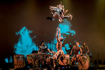 performers on stage spinning in mid air