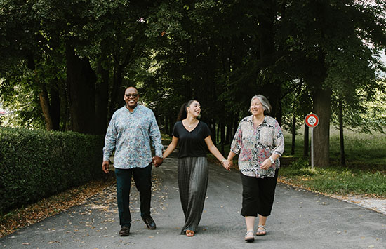 family walking through woods and path