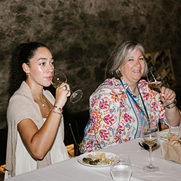 two ladies sipping wine at a tasting