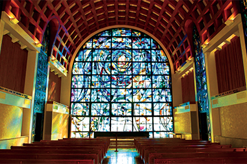 stained glass and pews inside Stauffer Chapel
