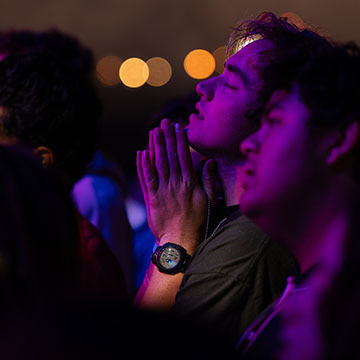 closeup of two worshipers with praying hands