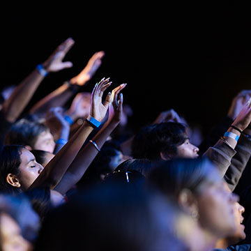 crowd with praise hands