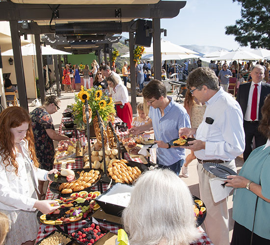 attendees serving at the German food table