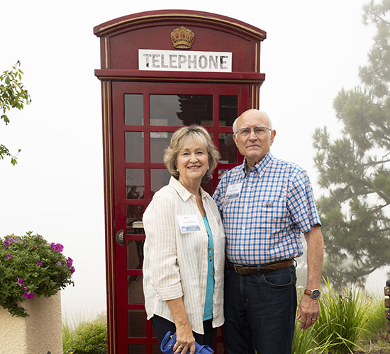 a couple posing in front of the telephone booth prop