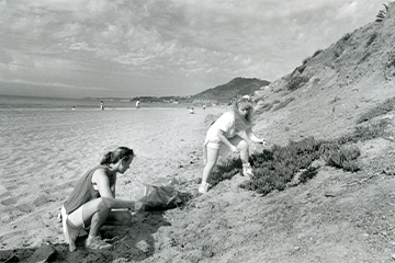 Two students cleaning up the beach for Step Forward Day in 1990