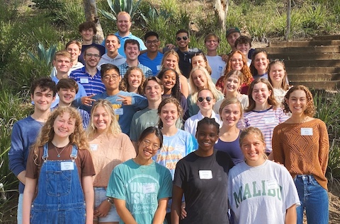 thirty students smiling, standing on steps